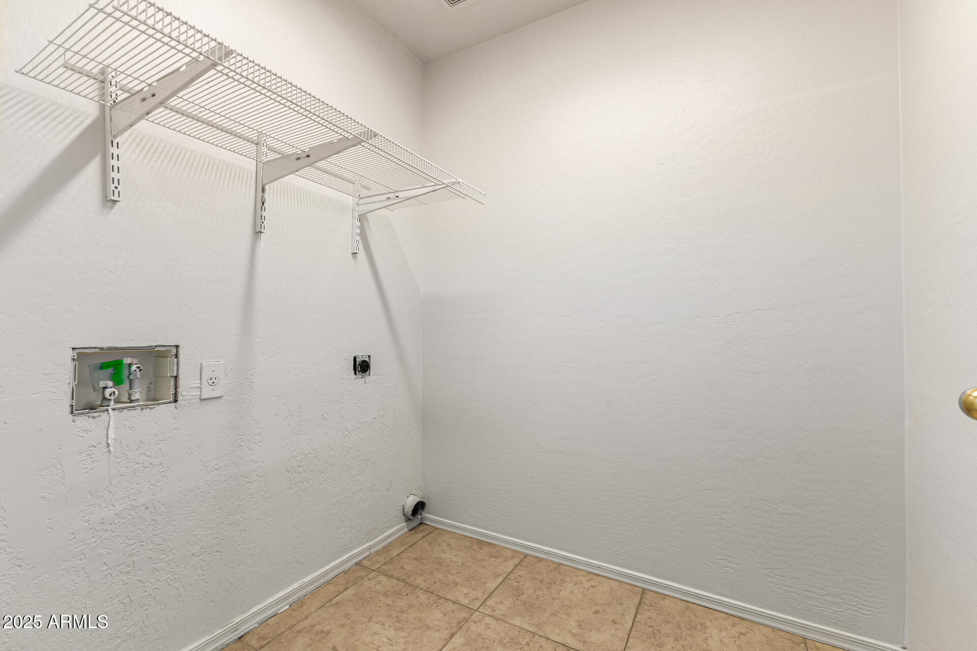 10628 West Coronado Road Avondale, AZ 85392 - Photo 24 of 29 a view of a room with racks on the wall