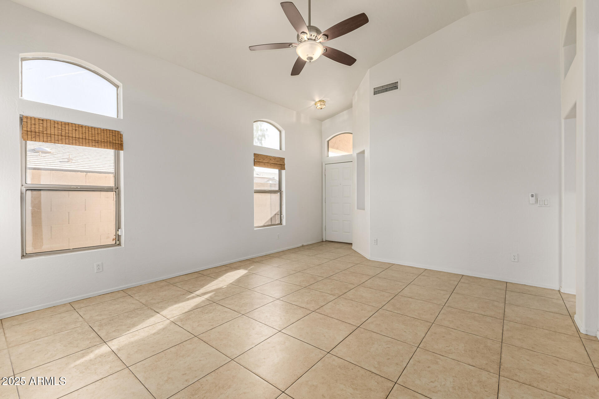 10628 West Coronado Road Avondale, AZ 85392 - Photo 4 of 29 an empty room with windows and fan