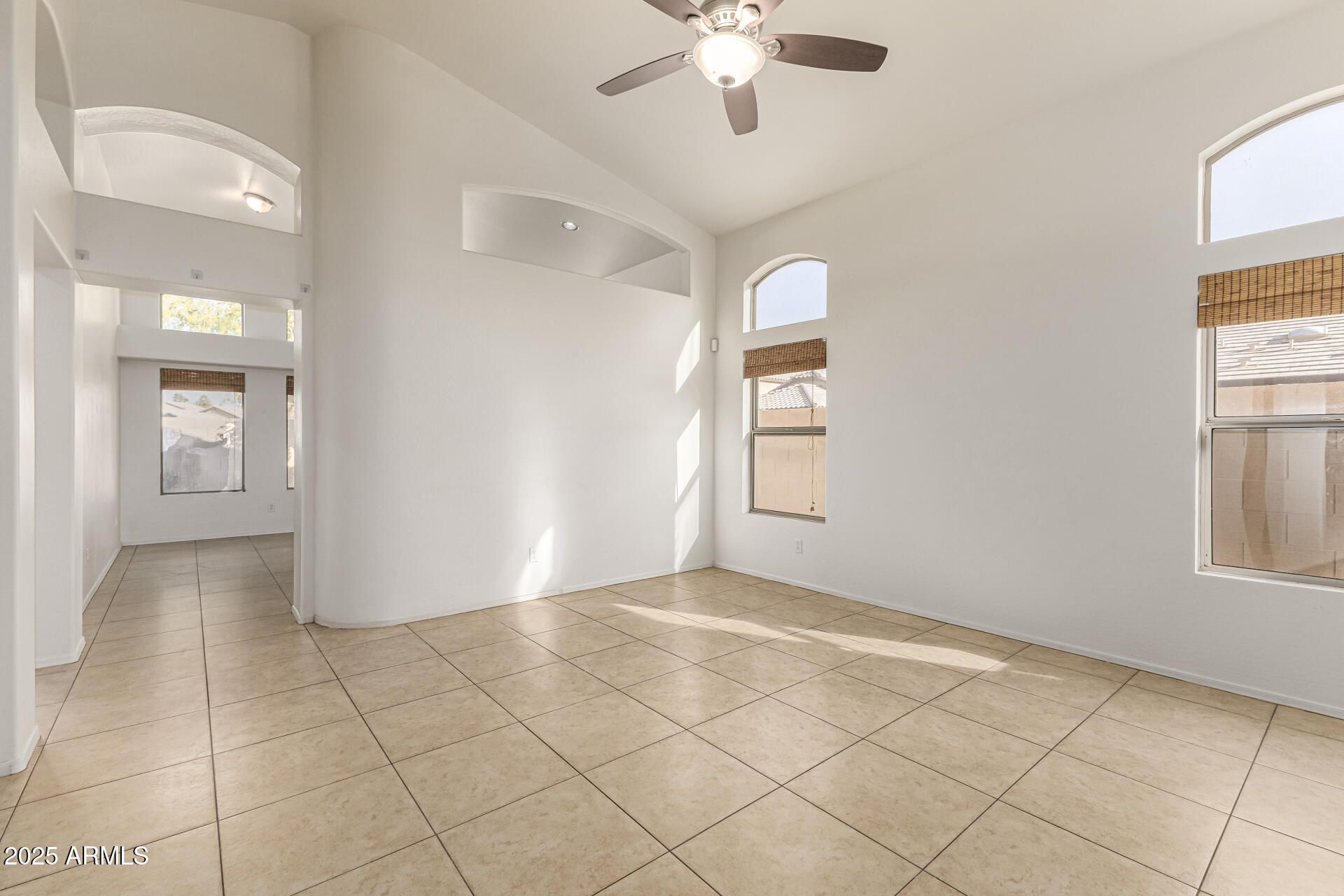 10628 West Coronado Road Avondale, AZ 85392 - Photo 5 of 29 an empty room with windows and fan