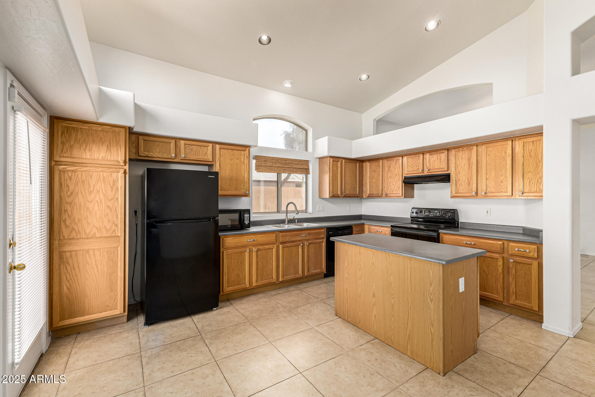 10628 West Coronado Road Avondale, AZ 85392 - Photo 8 of 29 a kitchen with stainless steel appliances granite countertop a refrigerator and a stove top oven