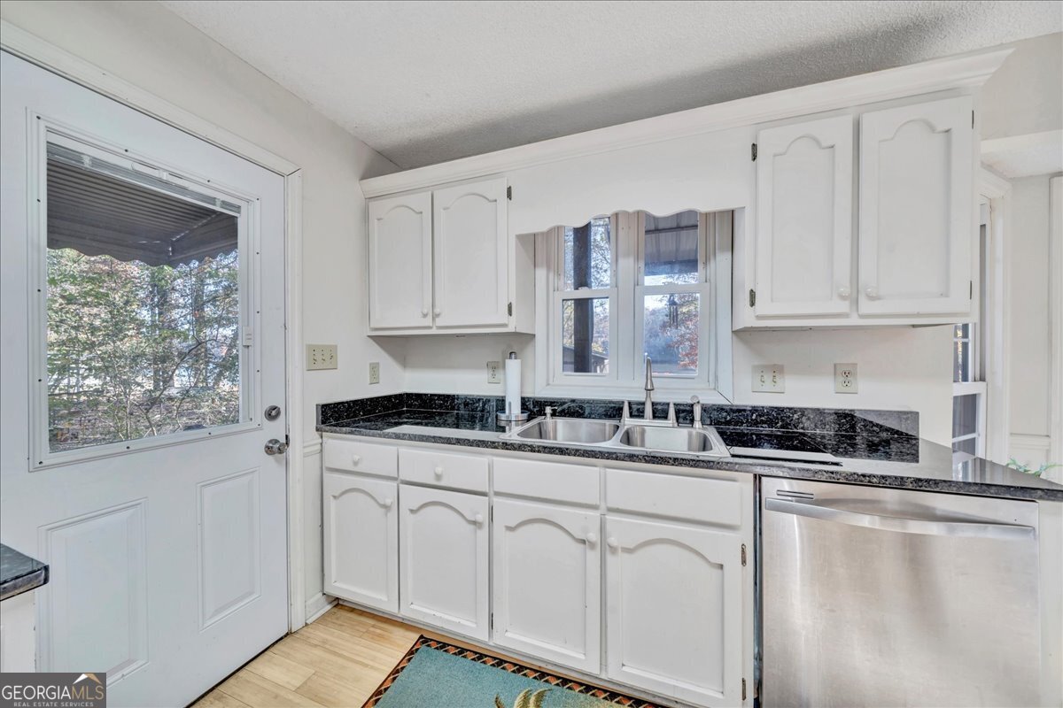 637 Will Scarlet Way Macon, GA 31220 - Photo 13 of 38 a kitchen with stainless steel appliances granite countertop a stove a sink and white cabinets