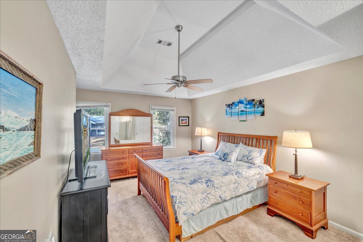 637 Will Scarlet Way Macon, GA 31220 - Photo 16 of 38 a bedroom with a bed and dresser with mirror