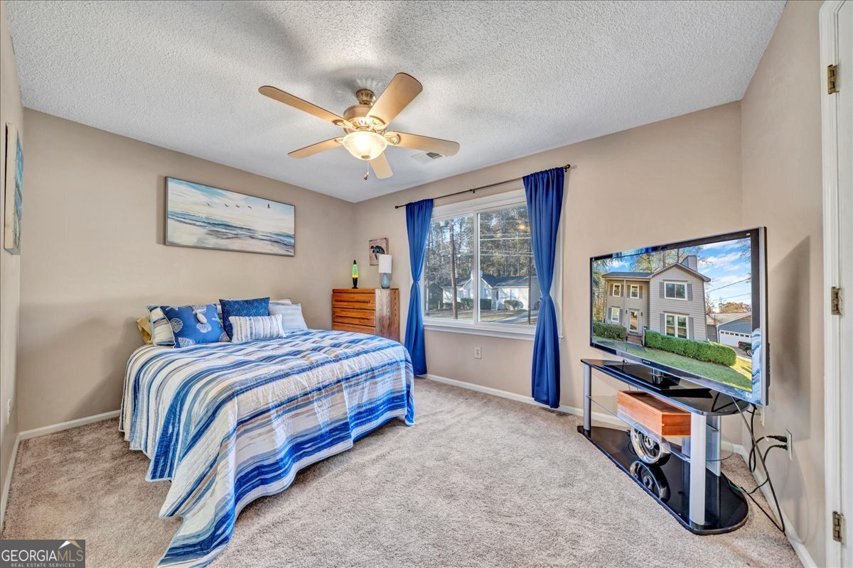 637 Will Scarlet Way Macon, GA 31220 - Photo 19 of 38 a bedroom with a bed and a flat screen tv