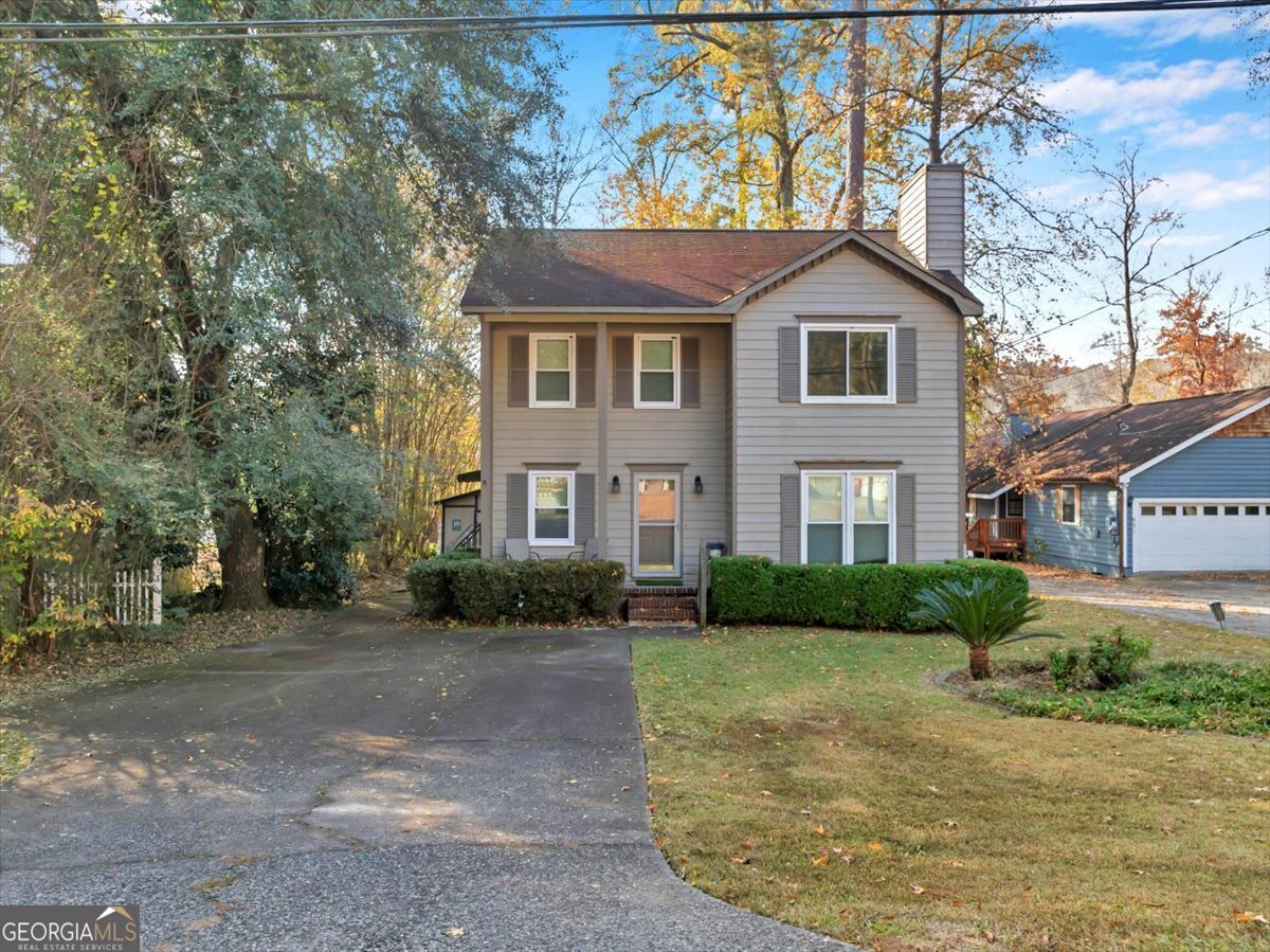 637 Will Scarlet Way Macon, GA 31220 - Photo 2 of 38 a front view of a house with a yard and garage