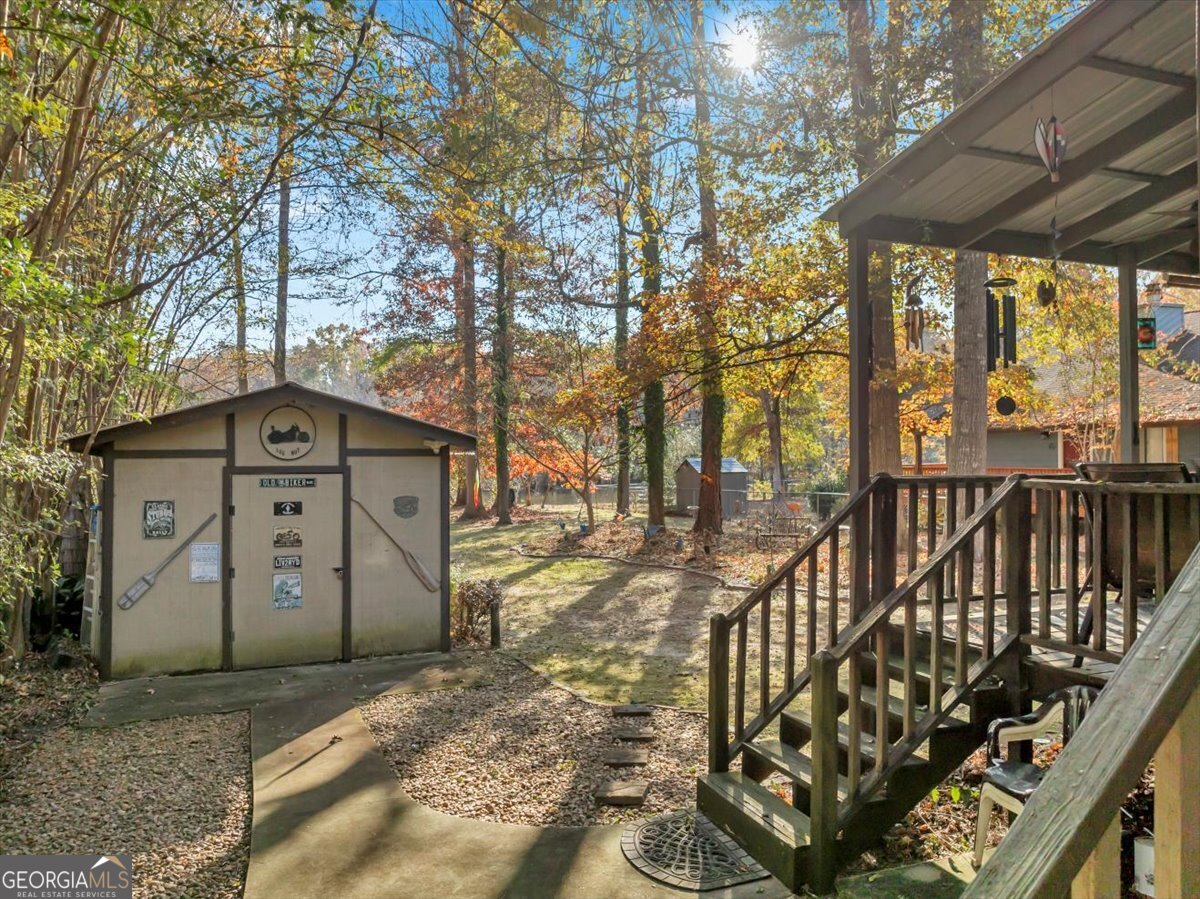 637 Will Scarlet Way Macon, GA 31220 - Photo 22 of 38 a view of a wooden house with large trees