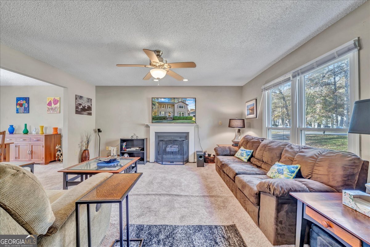 637 Will Scarlet Way Macon, GA 31220 - Photo 9 of 38 a living room with furniture a fireplace and a large window