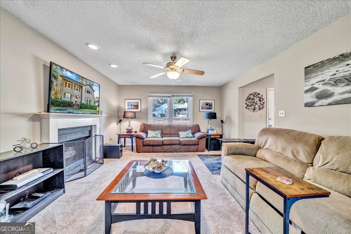 637 Will Scarlet Way Macon, GA 31220 - Photo 10 of 38 a living room with furniture a flat screen tv and a fireplace