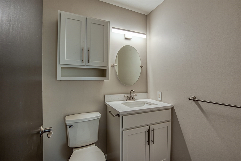 1329 Main Street, Unit 7 Brockton, MA 02301 - Photo 6 of 9 a bathroom with a toilet sink and mirror