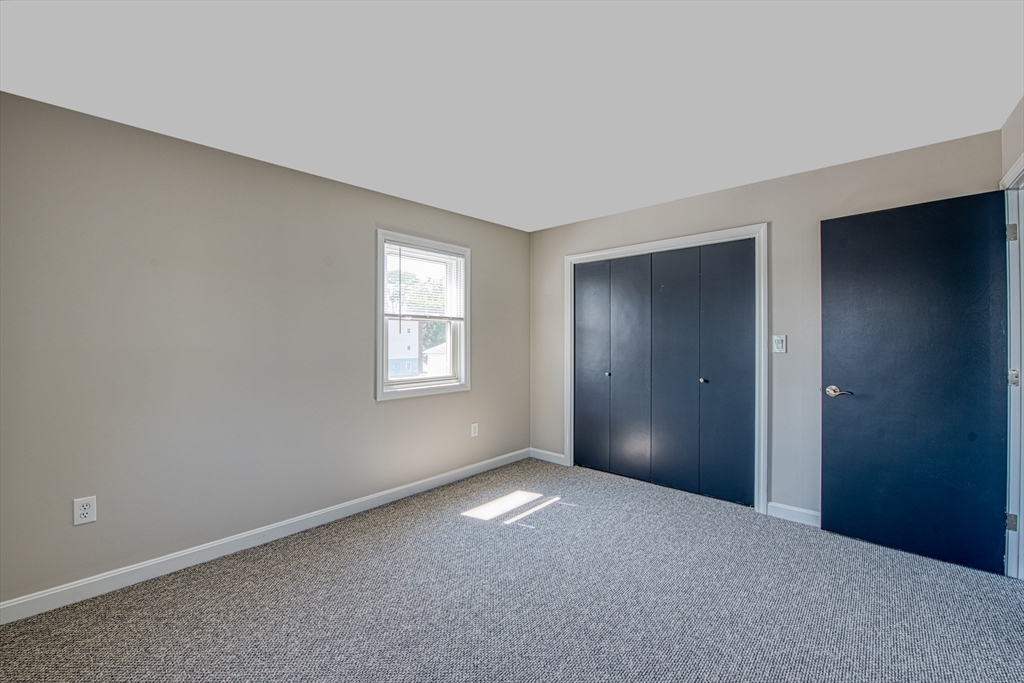 1329 Main Street, Unit 7 Brockton, MA 02301 - Photo 8 of 9 a view of an empty room with window and closet area
