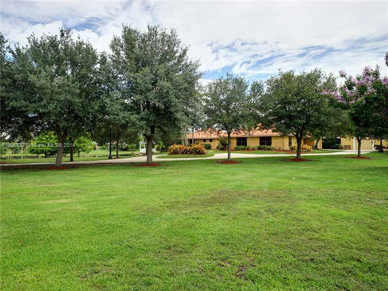 17641 Southwest 70th Place Southwest Ranches, FL 33331 - Photo 15 of 24 a view of grassy field with benches and trees all around