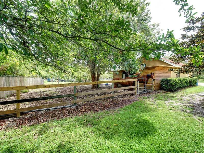 17641 Southwest 70th Place Southwest Ranches, FL 33331 - Photo 16 of 24 a backyard of a house with barbeque oven table and chairs