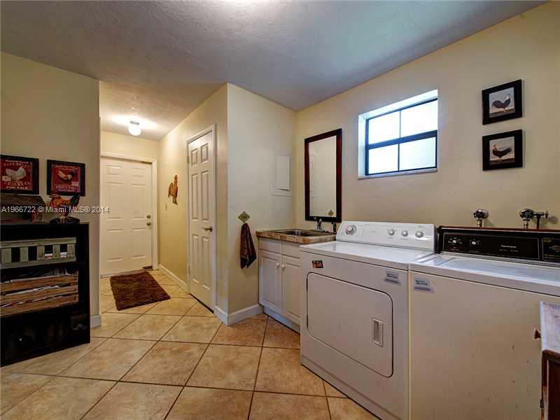 17641 Southwest 70th Place Southwest Ranches, FL 33331 - Photo 19 of 24 a room with a sink and cabinets