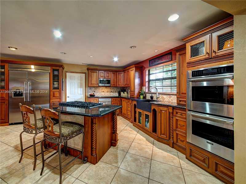 17641 Southwest 70th Place Southwest Ranches, FL 33331 - Photo 2 of 24 a kitchen with stainless steel appliances granite countertop a stove and a sink