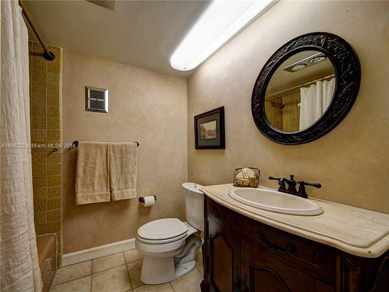 17641 Southwest 70th Place Southwest Ranches, FL 33331 - Photo 22 of 24 a bathroom with a sink a toilet and a mirror