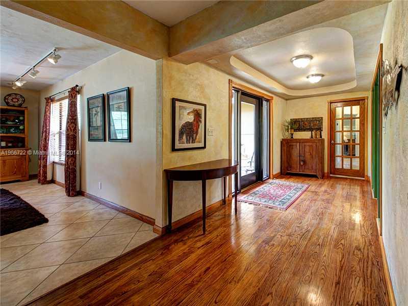 17641 Southwest 70th Place Southwest Ranches, FL 33331 - Photo 4 of 24 a view of a hallway with wooden floor and furniture