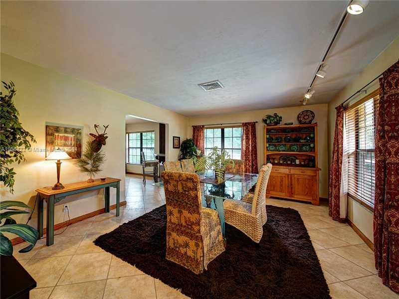 17641 Southwest 70th Place Southwest Ranches, FL 33331 - Photo 6 of 24 a living room with furniture fireplace and wooden floor