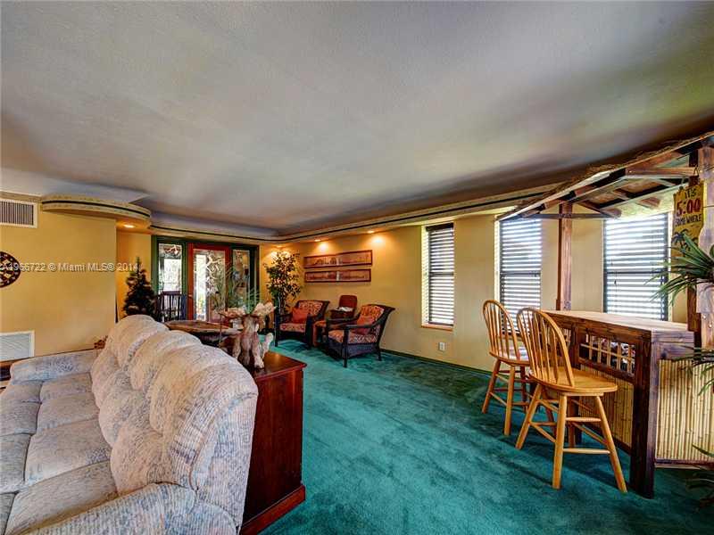 17641 Southwest 70th Place Southwest Ranches, FL 33331 - Photo 8 of 24 a living room with furniture and a large window