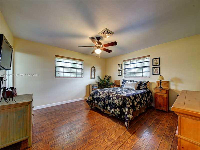 17641 Southwest 70th Place Southwest Ranches, FL 33331 - Photo 9 of 24 a bed room with a bed and a window