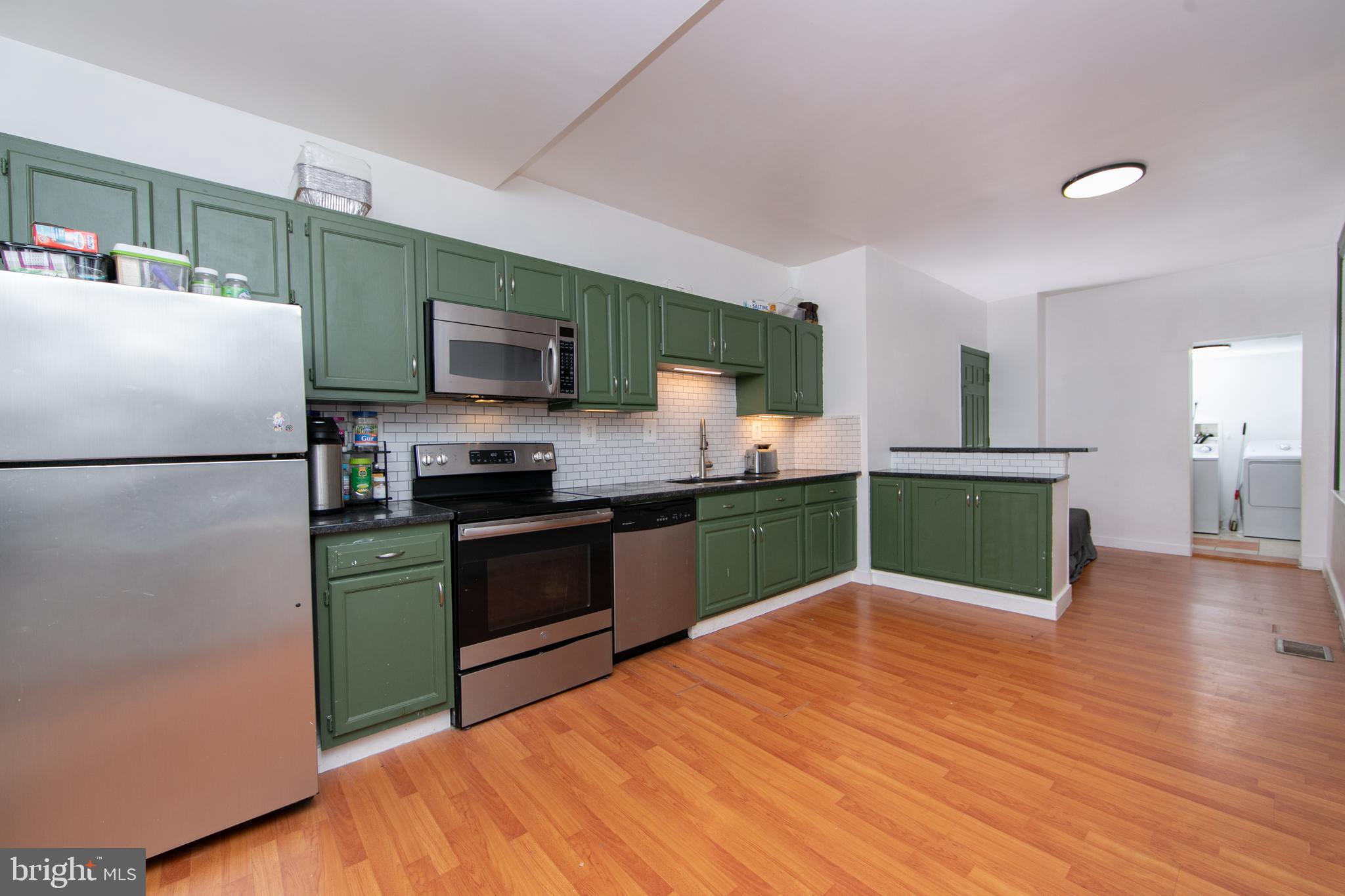 876 North 19th Street Philadelphia, PA 19130 - Photo 11 of 49 a kitchen with granite countertop a refrigerator and a stove top oven
