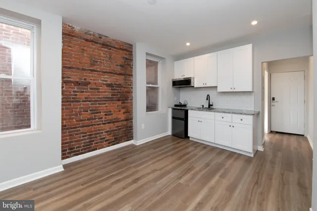 a view of kitchen with wooden floor