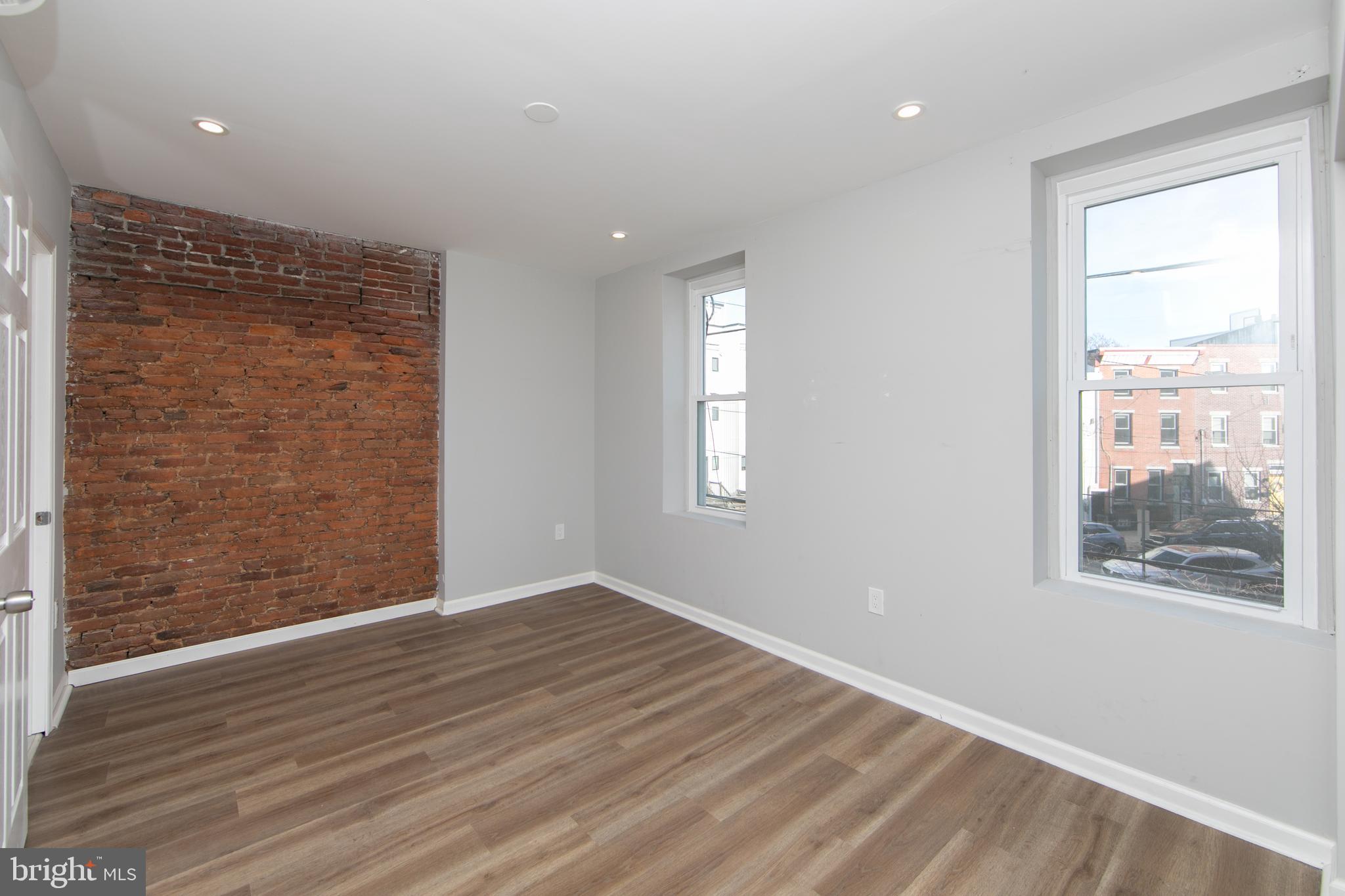 876 North 19th Street Philadelphia, PA 19130 - Photo 32 of 49 a view of an empty room with wooden floor and a window