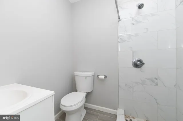 a white toilet sitting next to a white sink