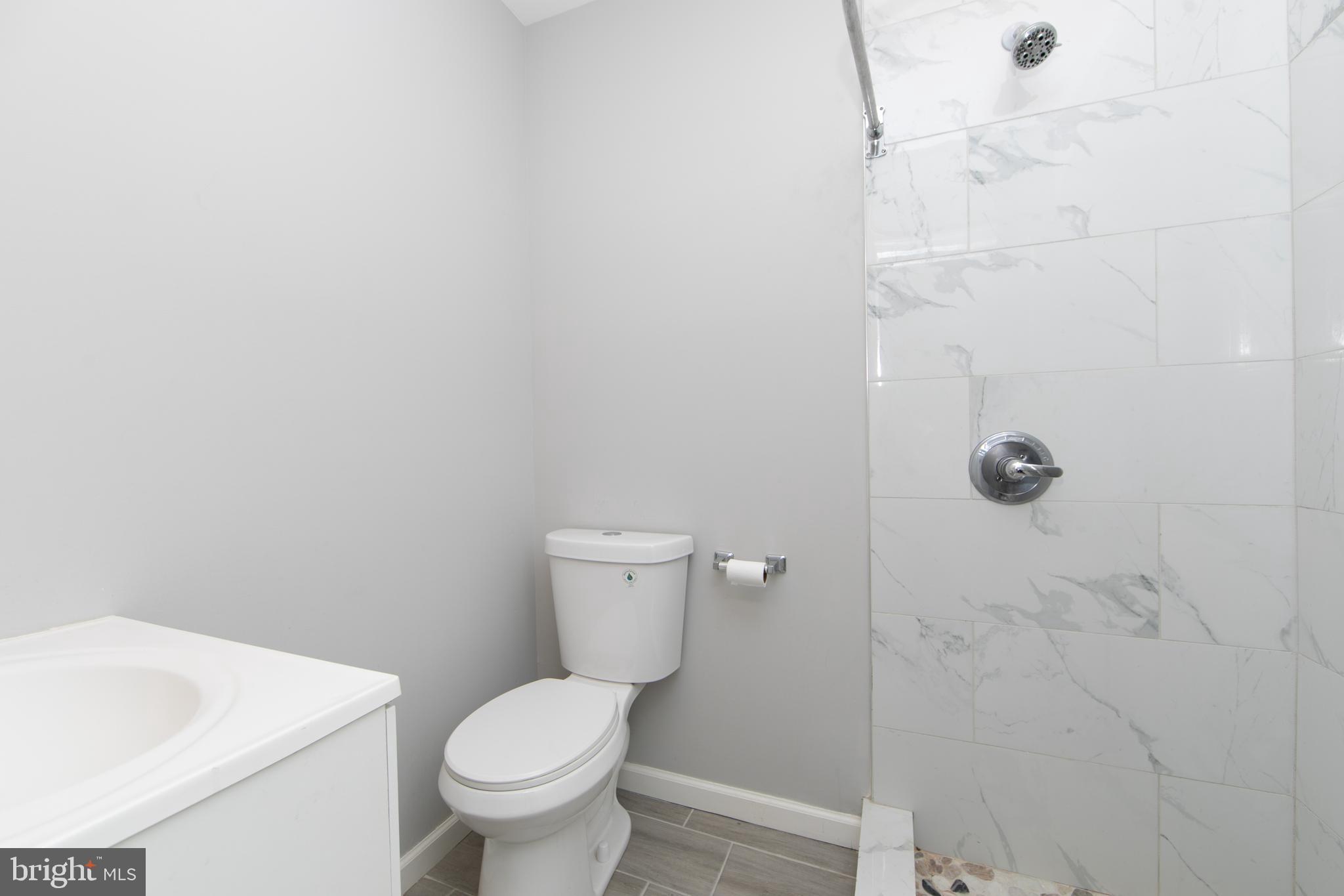 876 North 19th Street Philadelphia, PA 19130 - Photo 37 of 49 a white toilet sitting next to a white sink