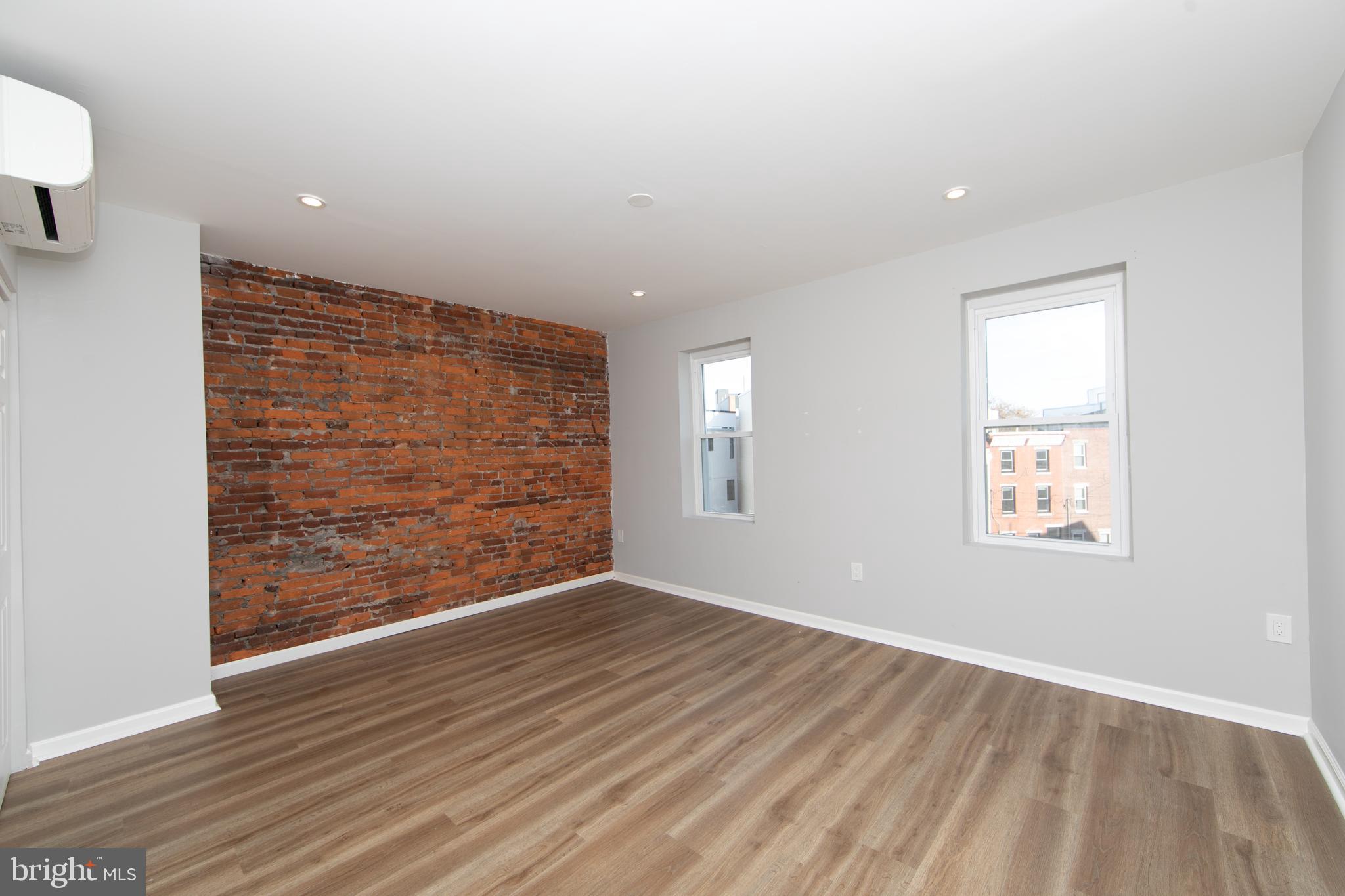876 North 19th Street Philadelphia, PA 19130 - Photo 41 of 49 an empty room with wooden floor and windows