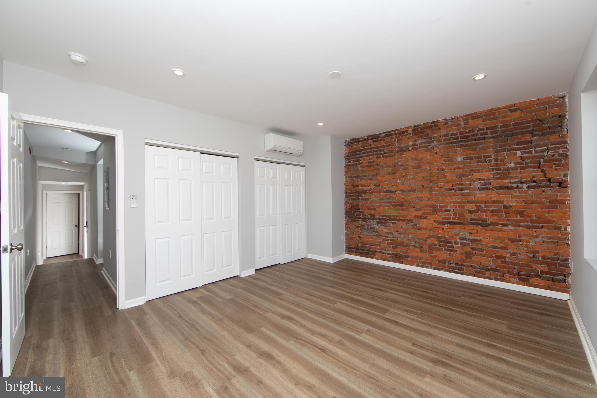 876 North 19th Street Philadelphia, PA 19130 - Photo 42 of 49 a view of an empty room with wooden floor and a window