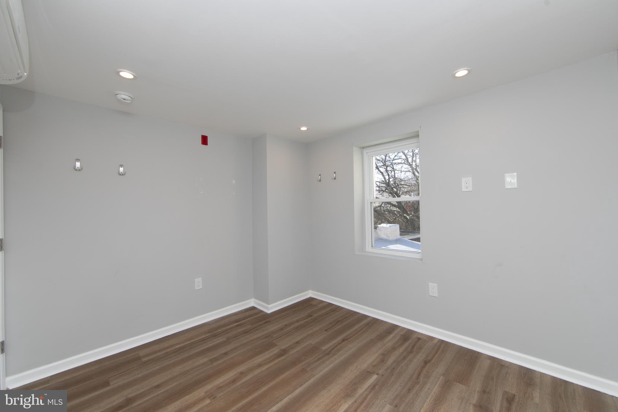 876 North 19th Street Philadelphia, PA 19130 - Photo 46 of 49 a view of an empty room with wooden floor and a window