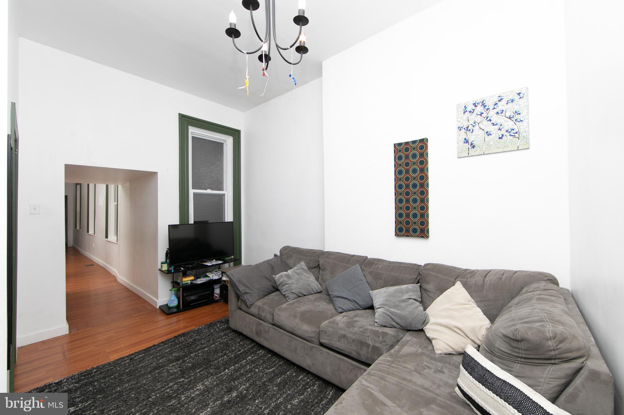 876 North 19th Street Philadelphia, PA 19130 - Photo 5 of 49 a living room with furniture and wooden floor