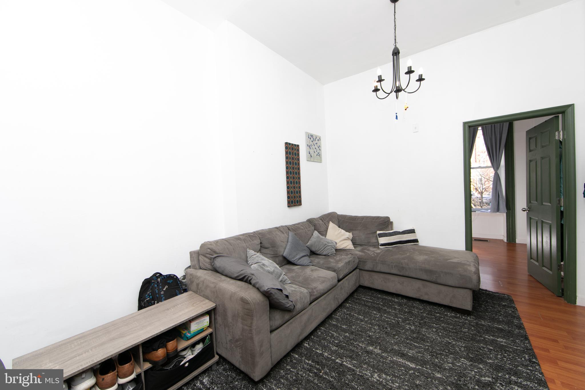 876 North 19th Street Philadelphia, PA 19130 - Photo 6 of 49 a living room with furniture and a chandelier