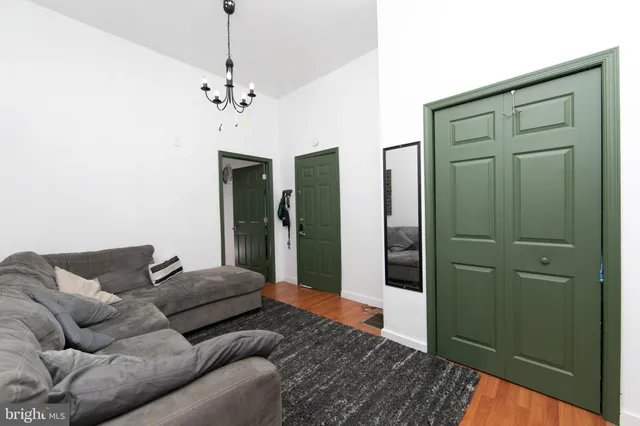 a living room with furniture and a chandelier