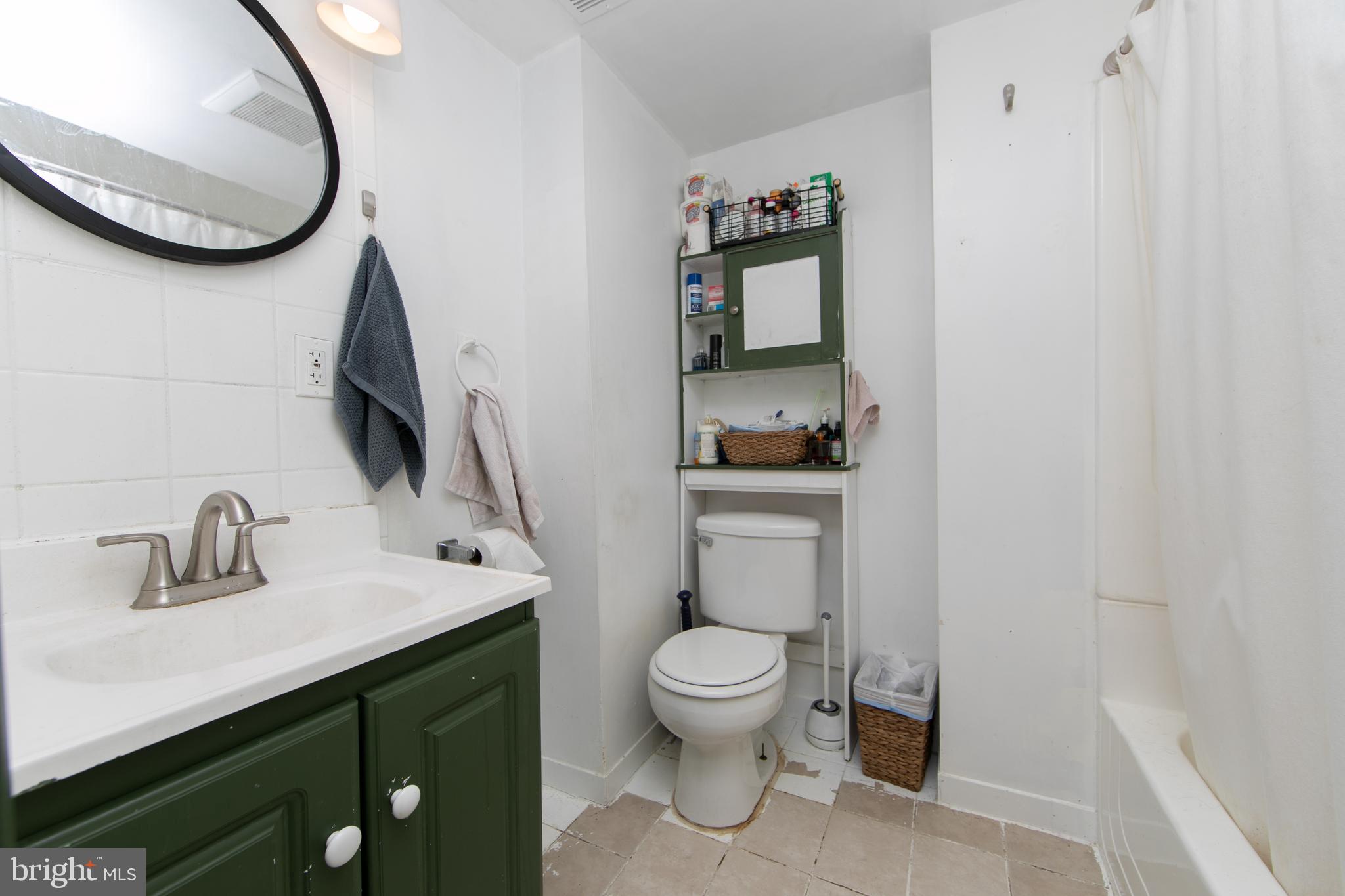 876 North 19th Street Philadelphia, PA 19130 - Photo 9 of 49 a bathroom with a toilet a sink and mirror