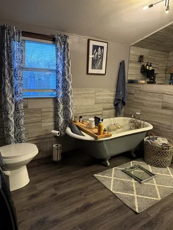 a room with table chairs and wooden floor