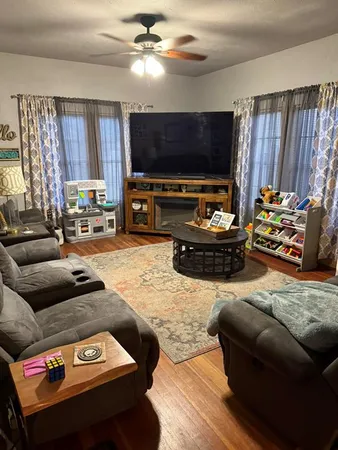 a living room with furniture and a flat screen tv