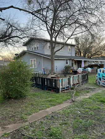 a view of a house with backyard and sitting area