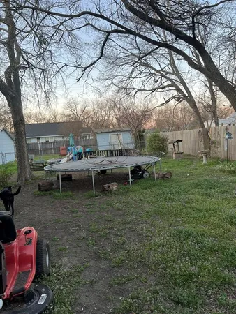 a backyard of a house with table and chairs