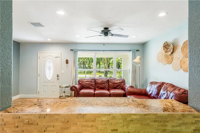a living room with furniture and a large window