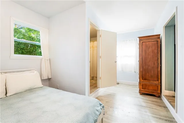 a bedroom with a bed and a window