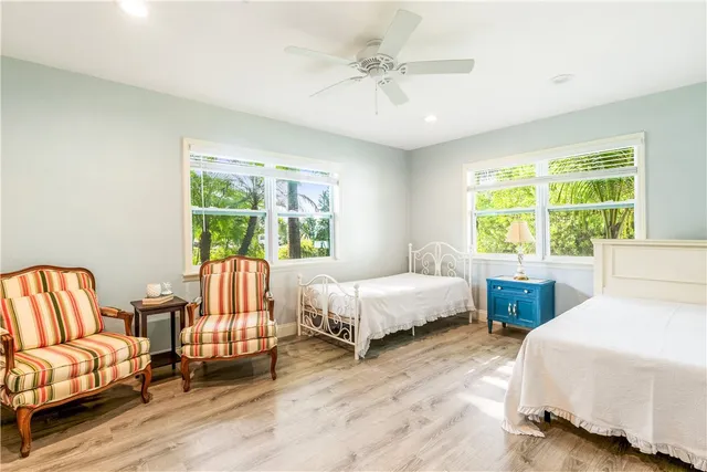 a bedroom with two beds and a couch