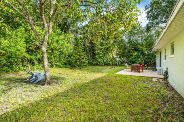 a backyard of a house with table and chairs