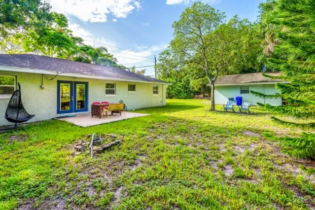 a view of a house with backyard sitting area and garden