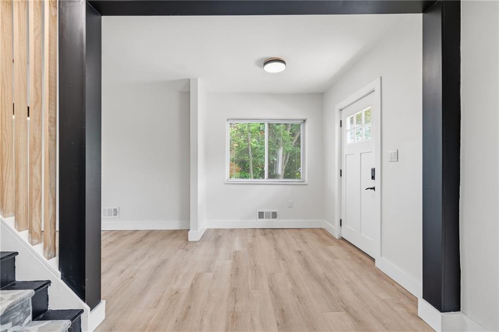 2961 Ruthwood Avenue Pittsburgh, PA 15227 - Photo 7 of 29 an empty room with wooden floor and windows