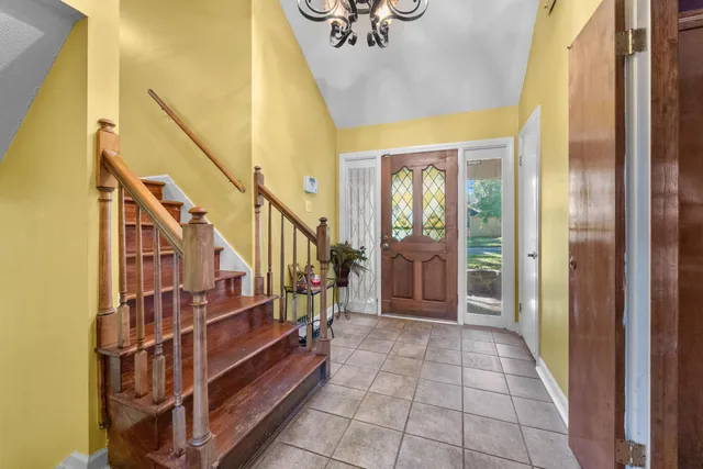 a view of entryway with wooden floor and stairs