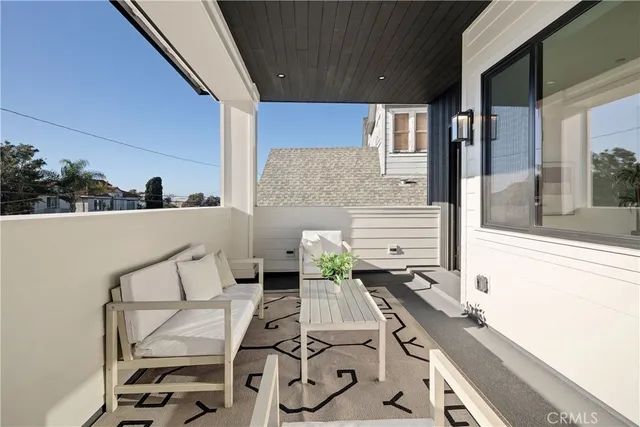 a balcony with table and chairs