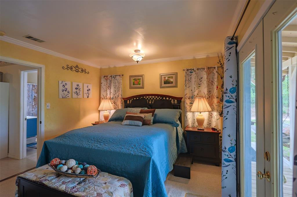 309 Tejas Trail Springtown, TX 76082 - Photo 17 of 40 a bedroom with a bed and wooden floor