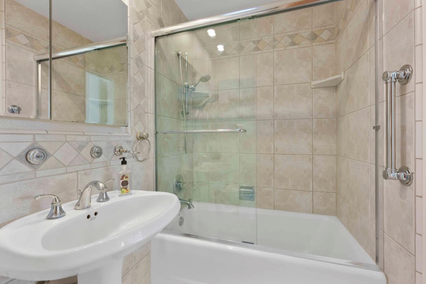 18373 Vanderbilt Drive Saratoga, CA 95070 - Photo 12 of 26 a white bath tub sitting next to a white sink and a shower