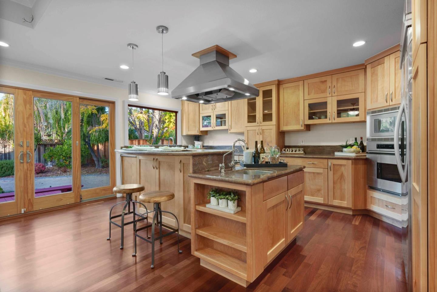 18373 Vanderbilt Drive Saratoga, CA 95070 - Photo 9 of 26 a kitchen with a stove a window and chairs