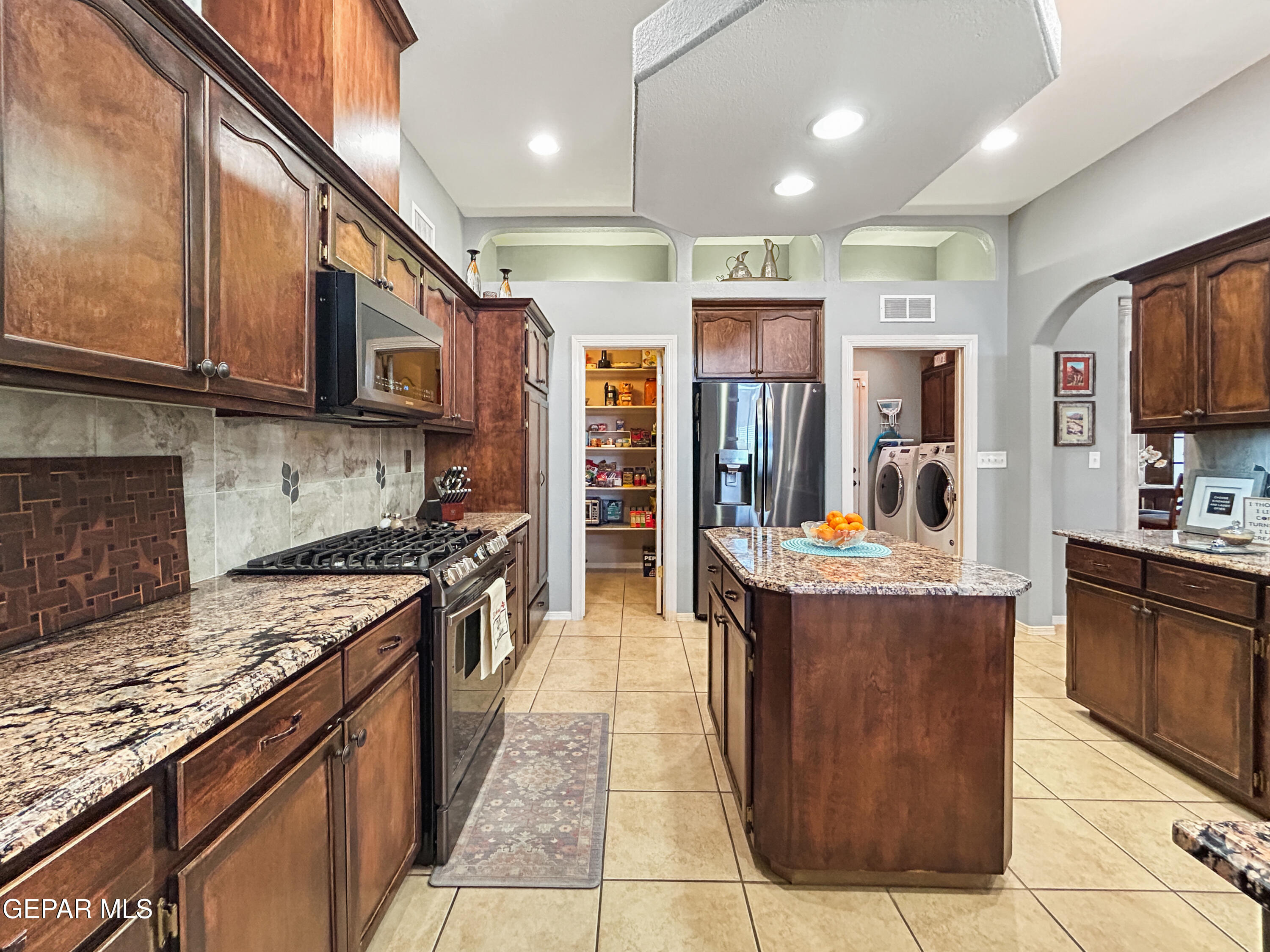 6680 Capitan Ridge El Paso, TX 79912 - Photo 33 of 47 a large kitchen with stainless steel appliances granite countertop a stove and a refrigerator